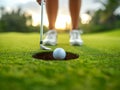 Golfer putting golf ball on the green grass, golf player putting golf ball into hole Royalty Free Stock Photo