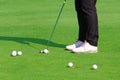 Golfer putting a golf ball in to hole Royalty Free Stock Photo