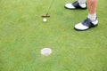 Golfer on the putting green at the hole Royalty Free Stock Photo