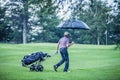 Golfer on a Rainy Day Leaving the Golf Course Royalty Free Stock Photo