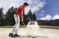 Golfer in sand trap.