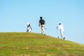 Golfer sport course golf ball fairway. Group People lifestyle man and friend playing game golf tee off on the green grass Royalty Free Stock Photo