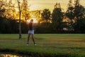 Golfer sport course golf ball fairway. People lifestyle woman playing game golf and swing golf ball go on green grass Royalty Free Stock Photo