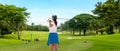 Golfer sport course golf ball fairway. People lifestyle woman playing game golf tee of blue sky background. Royalty Free Stock Photo
