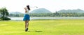 Golfer sport course golf ball fairway. People lifestyle woman playing game golf and hitting go on green grass river and mountain b