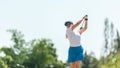 Golfer sport course golf ball fairway. People lifestyle woman playing game golf tee off on the green grass. Royalty Free Stock Photo