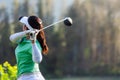 Golfer sport course golf ball fairway. People lifestyle woman playing game golf tee off on the green grass. Royalty Free Stock Photo