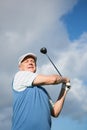 Golfer standing and swinging his club Royalty Free Stock Photo