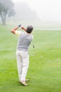 Golfer swinging his club on the course Royalty Free Stock Photo