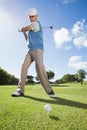 Golfer swinging his club on the course Royalty Free Stock Photo