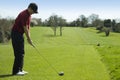 Golfer teeing off