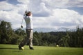 Golfer teeing off. Royalty Free Stock Photo