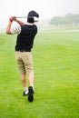 Golfer teeing off