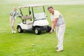 Golfer about to tee off with partner behind him Royalty Free Stock Photo