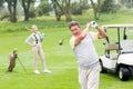 Golfer about to tee off with partner behind him Royalty Free Stock Photo