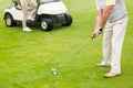 Golfer about to tee off with partner behind him Royalty Free Stock Photo