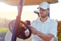 Golfer using cellphone app on cart Royalty Free Stock Photo