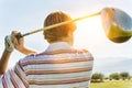 Golfer Watching Drive on Fairway with lens flare