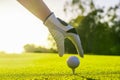 Golfer wearing glove placing golf ball on a tee at golf course Royalty Free Stock Photo