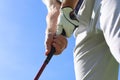 Golfer wearing a golf holding a putter