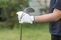 Golfer wearing white glove holding golf club