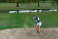 Golfer Woman Chip Golf Ball Out Of A Sand Trap. People Swing And Hitting Golf Course Is On The Fairway.