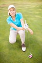 Golfer woman crouching on golf course Royalty Free Stock Photo