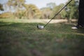 Golfers asia man show hit sweeping at green lawn. Low angle view Royalty Free Stock Photo