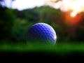 Get up close to the white golf ball of the athlete on a beautiful natural background. On the green lawn Royalty Free Stock Photo