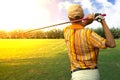 Golfers men player golf hit swing shot on course in sunrise. Royalty Free Stock Photo