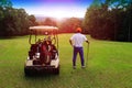 Golfers are playing golf and golf cart in the evening golf course