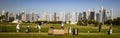 Golfers practice on driving range with Dubai skyline in the background