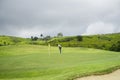 Golfers are putting golf in the evening golf course golf backglound. Golfer hitting golf ball Royalty Free Stock Photo