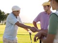 Golfers Shaking Hands On Golf Course