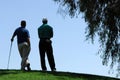 Golfers Wait For Turn To Putt