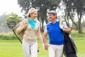 Golfing couple smiling at each other on the putting green Royalty Free Stock Photo