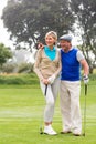 Golfing couple walking on the putting green Royalty Free Stock Photo