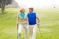 Golfing couple walking on the putting green Royalty Free Stock Photo