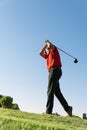 Golfist playing on golf course. Royalty Free Stock Photo