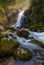 Gollinger Waterfall in Golling an der Salzach near Salzburg, Austria. Gollinger Wasserfall with mossy rocks and green trees,