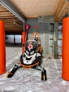 Golm, Austria, 24.12.2021. First aid snowmobile parked in garage in Austrian skiing resort. Vertical.
