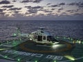 GOM, Mexico-20th February 2019: A Medevac Helicopter landing on a deck of a Ship at Night.