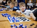 GOMEL, BELARUS - December 27, 2020: Festive New Year`s checkers tournament among children. Simultaneous game with champions for