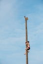 GOMEL, BELARUS - February 21, 2014: Young man climbs on a wooden Royalty Free Stock Photo