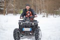 GOMEL, BELARUS - JANUARY 15, 2017: Country winter family holiday. Quad biking in the winter.