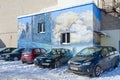 Parking in city courtyard. Graffiti with picture of landscape on wall of house, Gomel, Belarus