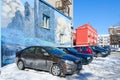 Parking in city courtyard. Graffiti with picture of landscape on wall of house, Gomel, Belarus