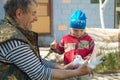 Gomel, Belarus - MAY 4, 2015: Grandfather grandson shows a white dove.