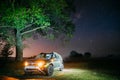 Night Starry Sky Above Car Renault Duster. SUV parked near lonely tree in night forest.