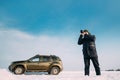 Gomel, Belarus. Young Man Taking Photo On Background Of Car Renault Duster Or Dacia Duster Suv Parked On Roadside At Royalty Free Stock Photo